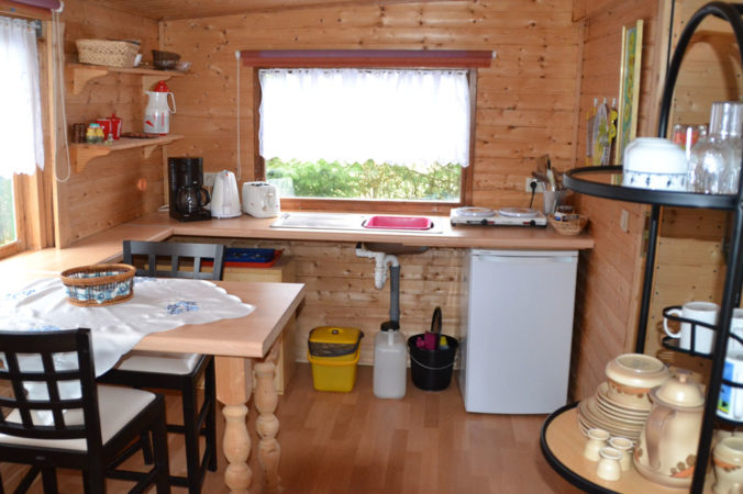 Mietwohnwagen 5 mit Küche und Esstisch Camping im Eichenwald
